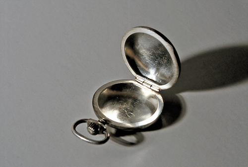 Untitled (infinity symbol engraved on interior of silver pocket watch case)